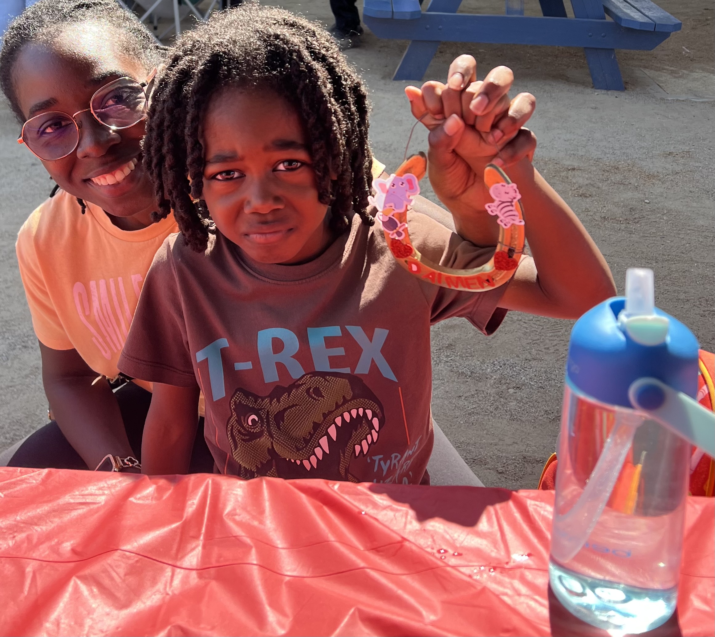 A camper and volunteer with a craft